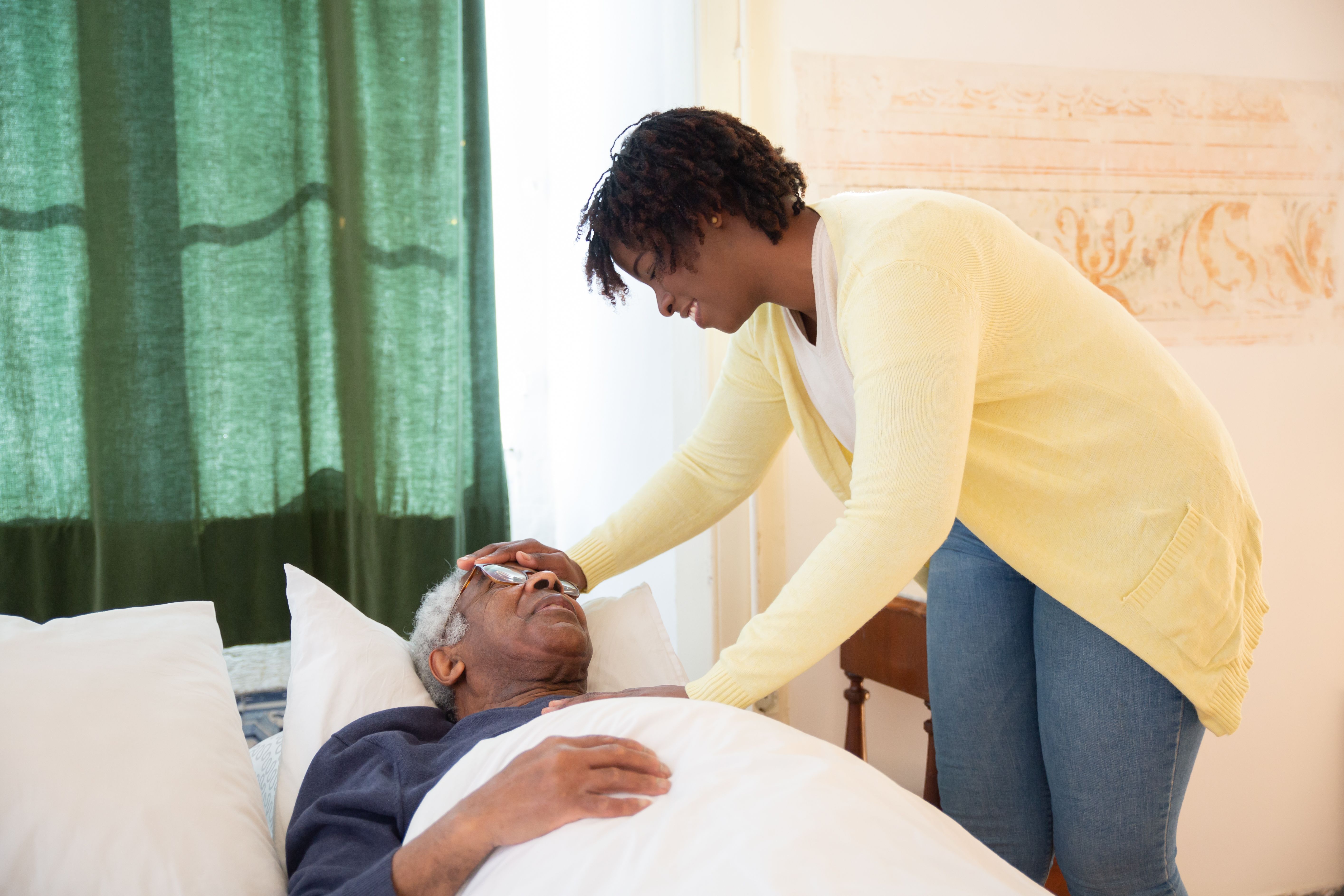 Caregiver assisting elderly resident